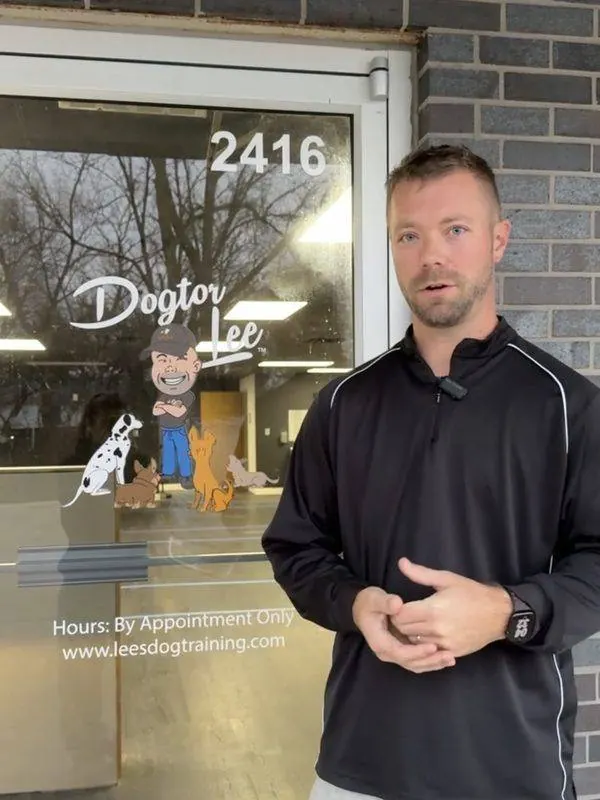 Lee Seibold in front of the Dogtor Lee sign on the door of his Huntington, IN training facility
